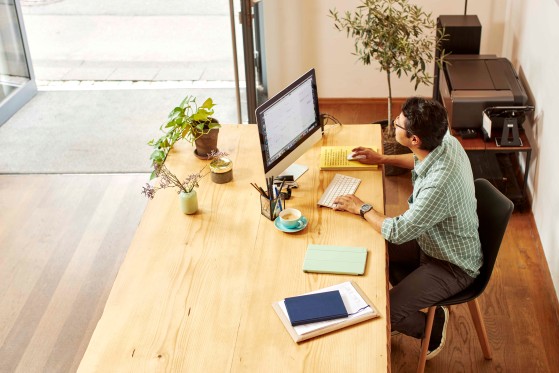 man downloading documents on his computer