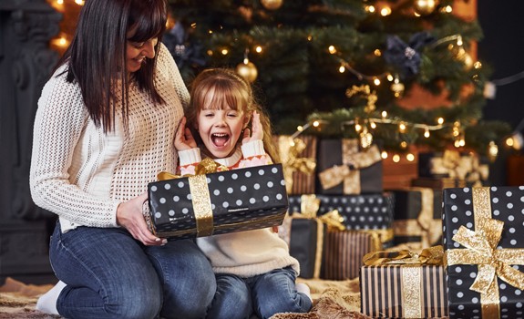 kid opening Christmas' presents