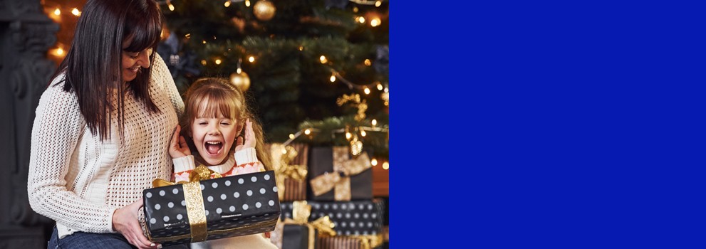 kid opening Christmas' presents